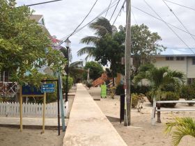 Placencia, Belize, raised sidewalk between houses – Best Places In The World To Retire – International Living
